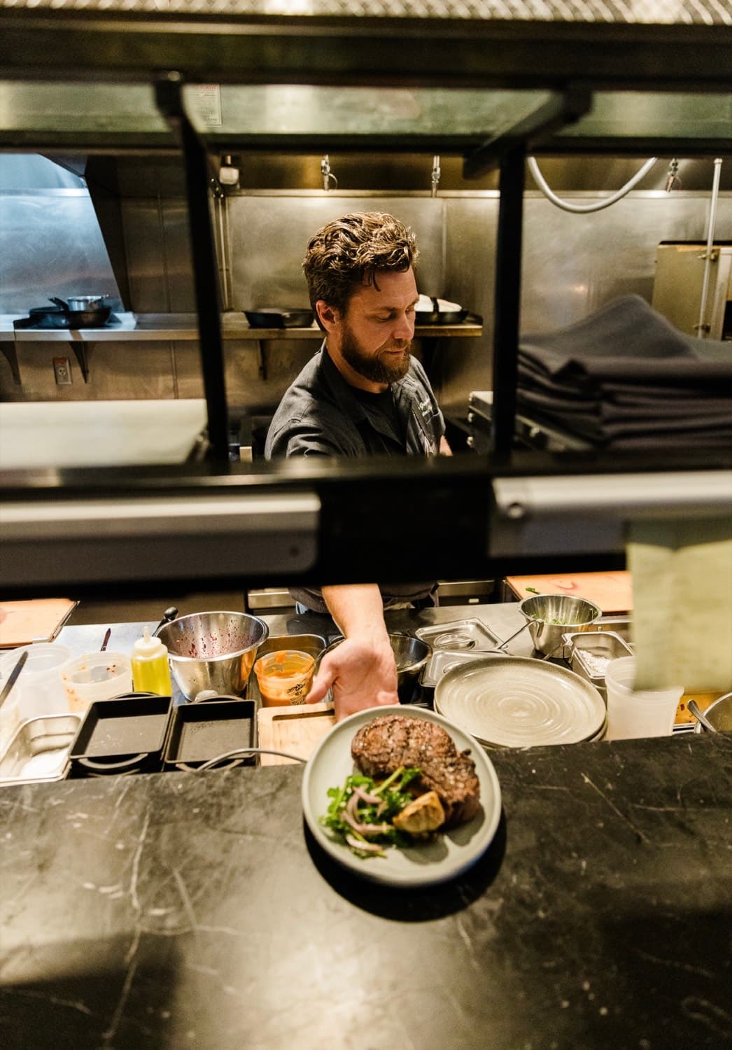 Chef Shane Graybeal preparing a private dinner course at the pass
